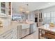 Kitchen view with a farmhouse sink, wine fridge, and island with marble countertop at 3707 5Th Ne Ave, Bradenton, FL 34208