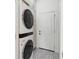 Practical laundry room featuring a stackable washer and dryer unit and storage cabinets at 3707 5Th Ne Ave, Bradenton, FL 34208