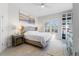 Serene main bedroom with neutral tones, shuttered window, and custom closet system at 3707 5Th Ne Ave, Bradenton, FL 34208