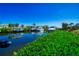 Picturesque waterfront view of homes with boats docked along the canal, surrounded by lush greenery at 3707 5Th Ne Ave, Bradenton, FL 34208