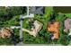 An aerial view showcases the neighborhood, homes with pools, and tree-lined street at 402 Walls Way, Osprey, FL 34229