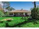 Spacious backyard with lush lawn, mature trees, and inviting patio seating area at 402 Walls Way, Osprey, FL 34229