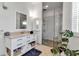 Bright bathroom featuring a glass-enclosed shower, modern vanity, and stylish tile work at 402 Walls Way, Osprey, FL 34229