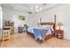This bright bedroom features wood floors, a four-poster bed, a chandelier, and a desk at 402 Walls Way, Osprey, FL 34229