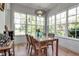 Cozy dining area with hardwood floors, large windows, and modern lighting at 402 Walls Way, Osprey, FL 34229