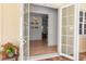Inviting entryway with double glass doors leading to a well-lit foyer and views of the home's interior at 402 Walls Way, Osprey, FL 34229