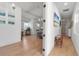 Bright hallway leading to a cozy living space, hardwood floors and neutral colors at 402 Walls Way, Osprey, FL 34229