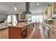 Well-equipped kitchen featuring custom cabinetry, a spacious island, and hardwood floors and open layout at 402 Walls Way, Osprey, FL 34229