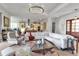Spacious living room with a modern fireplace, large sectional sofa, and an open-concept design to kitchen at 402 Walls Way, Osprey, FL 34229