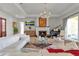Elegant living room featuring a fireplace, piano, and a comfortable white sofa at 402 Walls Way, Osprey, FL 34229