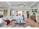 Bright living room with high ceilings, modern decor, and hardwood floors at 402 Walls Way, Osprey, FL 34229