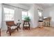 Bright main bedroom features a sitting area near the windows, light hardwood floors, and built-in entertainment center at 402 Walls Way, Osprey, FL 34229