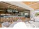 Stylish outdoor bar and dining area with a bar, televisions and a serene view at 402 Walls Way, Osprey, FL 34229