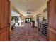 Covered outdoor living space featuring brick flooring, ceiling fans, and an inviting ambiance at 402 Walls Way, Osprey, FL 34229