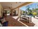 Inviting outdoor patio features brick pavers, a dining area, and a view of the pool surrounded by lush landscaping at 402 Walls Way, Osprey, FL 34229