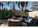 Inviting patio area with comfortable seating around a fire pit, perfect for outdoor gatherings at 402 Walls Way, Osprey, FL 34229