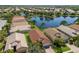 Stunning aerial view of homes backing onto a serene lake in a lush community with beautiful landscaping and tile roofs at 4134 63Rd E Ter, Sarasota, FL 34243