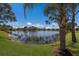 Tranquil lake view from the lush green backyard of this residence at 4134 63Rd E Ter, Sarasota, FL 34243