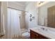Bathroom with shower and tub combination, cherry wood vanity, and large mirror at 4134 63Rd E Ter, Sarasota, FL 34243