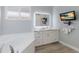 Bathroom showcasing a soaking tub, wood-look floors, and an LED mirror at 4134 63Rd E Ter, Sarasota, FL 34243