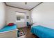 Bedroom with two twin beds, a window with blinds, and a small study area at 4134 63Rd E Ter, Sarasota, FL 34243