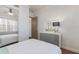 Bedroom with white walls, wood-look flooring, large mirror closet, and white dresser with mirror at 4134 63Rd E Ter, Sarasota, FL 34243