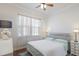 Bright bedroom features neutral decor, ceiling fan, and large window letting in natural light at 4134 63Rd E Ter, Sarasota, FL 34243