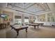 Upscale billiard room with multiple pool tables and elegant lighting fixtures for residents enjoyment at 4134 63Rd E Ter, Sarasota, FL 34243