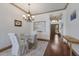 Elegant dining room with wood floors, chandelier, glass table, and neutral decor at 4134 63Rd E Ter, Sarasota, FL 34243