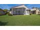 Exterior showcasing screened lanai and lush lawn at 4134 63Rd E Ter, Sarasota, FL 34243