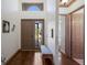Bright foyer with hardwood floors, high ceilings, a decorative bench, and views to other rooms at 4134 63Rd E Ter, Sarasota, FL 34243