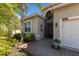 Inviting home entrance featuring a brick walkway, lush landscaping, and a charming flower display at 4134 63Rd E Ter, Sarasota, FL 34243