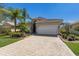 Attractive single-story home featuring well-manicured lawn, brick border, and paver driveway to a 2-car garage at 4134 63Rd E Ter, Sarasota, FL 34243