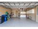 Spacious two car garage with speckled epoxy flooring, storage cabinets, and a side entrance at 4134 63Rd E Ter, Sarasota, FL 34243