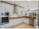 Kitchen with white cabinets, stainless steel appliances, granite countertops, and a view of the living area at 4134 63Rd E Ter, Sarasota, FL 34243