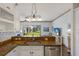 Well-equipped kitchen with stainless steel appliances, granite countertops, white cabinets, and an open view to the backyard at 4134 63Rd E Ter, Sarasota, FL 34243
