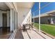 Screened lanai with a table, chairs, and view of the lawn at 4134 63Rd E Ter, Sarasota, FL 34243