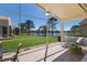 Screened lanai with brick flooring overlooks a peaceful lake view with lush greenery and mature trees at 4134 63Rd E Ter, Sarasota, FL 34243