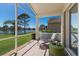 Screened lanai with view of lake and well-manicured lawn; lounge chair at 4134 63Rd E Ter, Sarasota, FL 34243