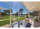 Screened lanai with outdoor dining and relaxing views of lawn and lake at 4134 63Rd E Ter, Sarasota, FL 34243
