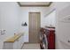 Laundry room with a washer and dryer, white cabinets, a long countertop, and a door to a utility closet at 4134 63Rd E Ter, Sarasota, FL 34243