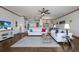 Open-concept living room with hardwood floors, stylish furnishings, and seamless access to the kitchen and dining area at 4134 63Rd E Ter, Sarasota, FL 34243