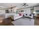 Open floor plan living room with ceiling fan, neutral walls, and a view of the kitchen and dining area at 4134 63Rd E Ter, Sarasota, FL 34243