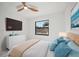 Cozy bedroom featuring a bright window, soft decor, and ample closet space at 4444 Robin Hood Trl W, Sarasota, FL 34232