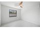 Bedroom with ceiling fan and window at 4444 Robin Hood Trl W, Sarasota, FL 34232