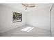 Clean, airy bedroom with a ceiling fan, a large window, and ample closet space at 4444 Robin Hood Trl W, Sarasota, FL 34232