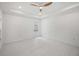 Bright bedroom with white walls, floors, ceiling fan, and access to outdoor pool at 4444 Robin Hood Trl W, Sarasota, FL 34232