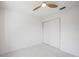 Clean and bright bedroom featuring a ceiling fan, closet doors, and neutral decor with lots of natural light at 4444 Robin Hood Trl W, Sarasota, FL 34232