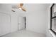 Bedroom with ceiling fan, closet and window at 4444 Robin Hood Trl W, Sarasota, FL 34232