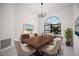 Elegant dining room with a dark wood table, chandelier and view of the backyard at 4444 Robin Hood Trl W, Sarasota, FL 34232
